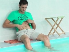 Solo guy sits poolside and jerks off